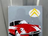 painting of a red car on a metal surface with a yellow arrow above it