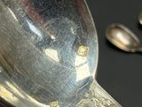 a silver spoon and a silver spoon on a black table