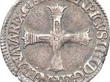 a close up of a coin with a cross on it