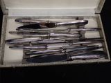 a bunch of knives in a box on a table