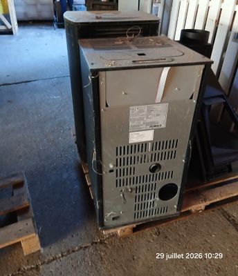 a old furnace sitting on a pallet in a garage