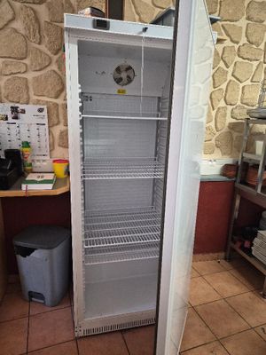 an image of a refrigerator in a kitchen with a clock on the door