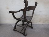 a wooden chair that is sitting in front of a wall