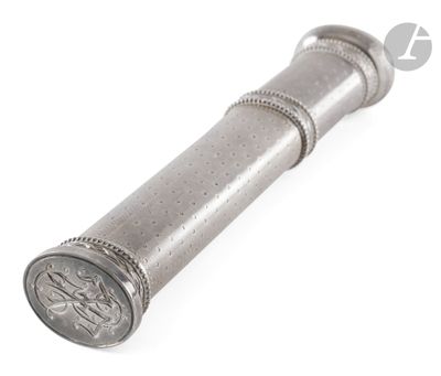 a silver metal object on a white surface