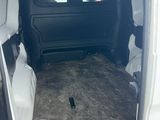 a white van with the door open in a parking lot