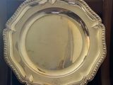 a silver plate sitting on top of a chair