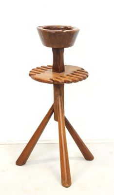a wooden stand with a bowl on top of it