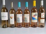 several bottles of wine are lined up on a table