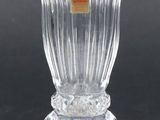 a clear glass vase with a yellow label on it