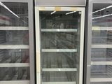 two empty refrigerators in a store that are empty
