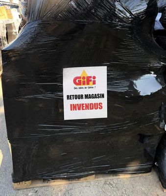a pile of black garbage bags with a sign on it