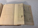 an open book with drawings on it on a table