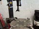 a machine that is sitting on the ground next to some barrels