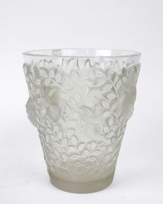 a glass vase with a flower design on it