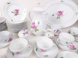 a lot of plates and cups on the table