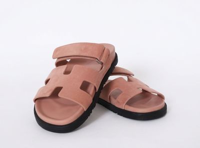 a close up of a pair of pink sandals on a white background