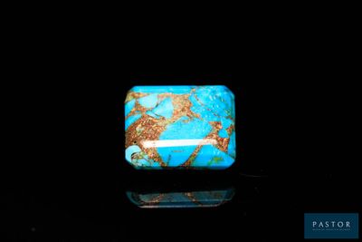 a blue and gold stone with a black background