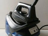a black and blue steam iron sitting on a counter