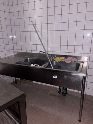a sink in a kitchen with a towel on the counter