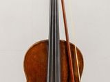 a violin and a bow on display on a table