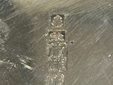 a close up of a metal object with a cross on it
