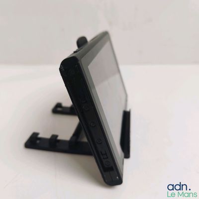 a small tablet computer on a stand on a table