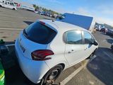 a white car parked in a parking lot next to other cars