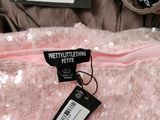 pink sequinned dress with tags on the back of it