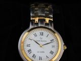 a silver and gold watch with roman numerals on it