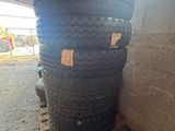 a stack of tires sitting on a pallet next to a wall