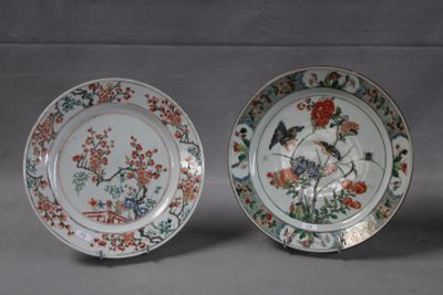 two plates with birds and flowers on them sitting next to each other
