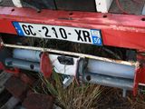 a red and white truck with a number plate on it