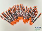 an image of a group of orange and black pencils sitting on top of each other