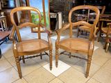 two chairs that are sitting in a room together