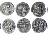 a close up of a bunch of silver coins on a white surface