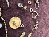 many different types of jewelry on a purple cloth
