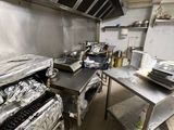 a large kitchen with a lot of food on the counter