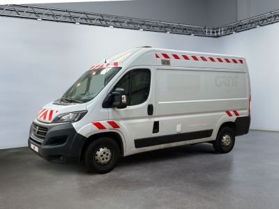 a white van with red stripes parked in a garage