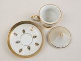 two cups and a saucer sitting on a table