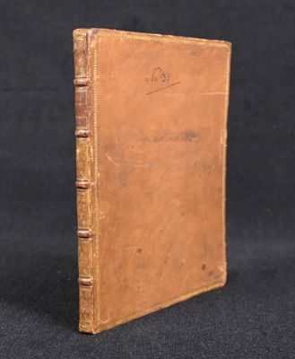 an old book sitting on top of a black surface