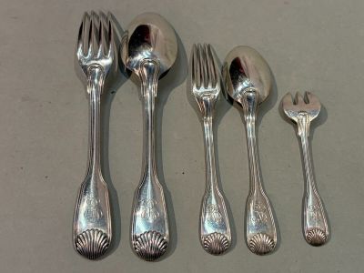 five spoons and a fork on a table