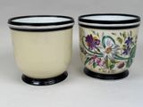 two cups that are sitting next to each other on a table