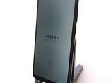 the back of a black phone with the screen open on a stand