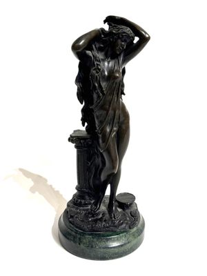 a bronze statue of a woman holding a flower pot