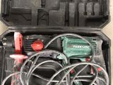 a box with a corded drill and a corded hammer in it