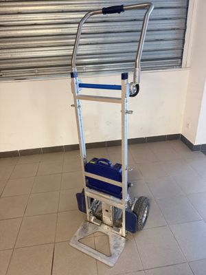 a hand truck with a blue bag on it in a room