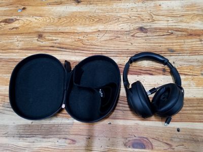 a pair of headphones sitting in a case on a wooden floor