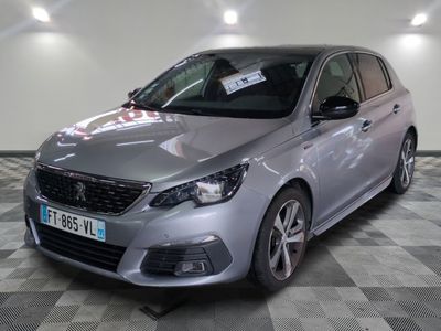 the silver car is parked in the showroom on the checkered floor