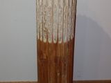 a tall vase that is sitting on a wooden stand