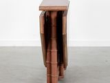 a small table with a folding top and a wooden base